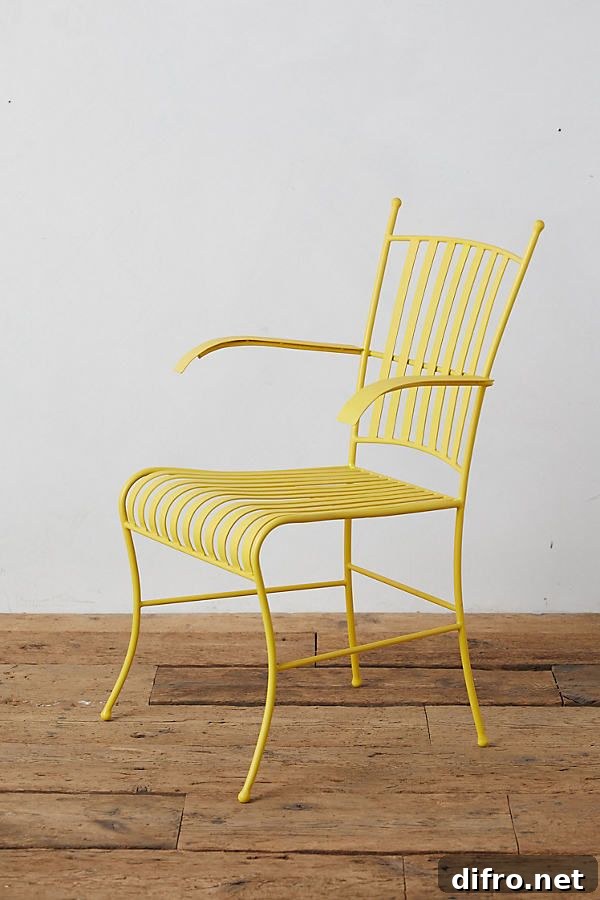 Yellow steel armchair on wood floor