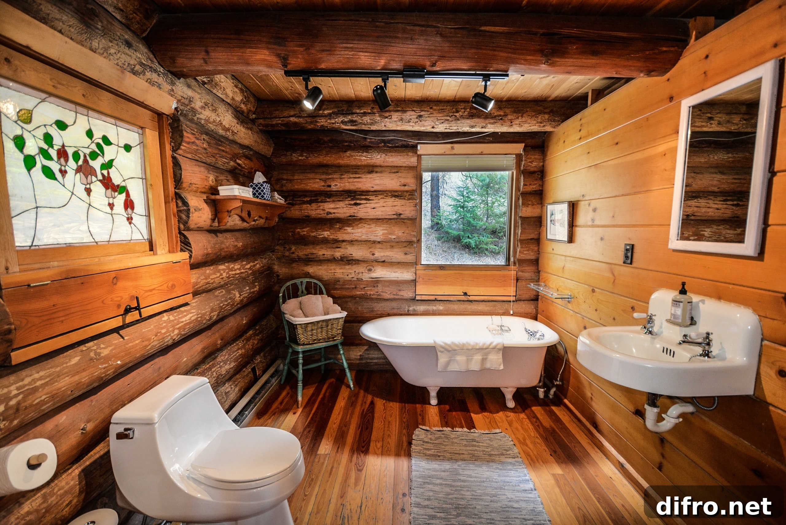 Wood bathroom walls and floor with white tub, white sink and white toilet