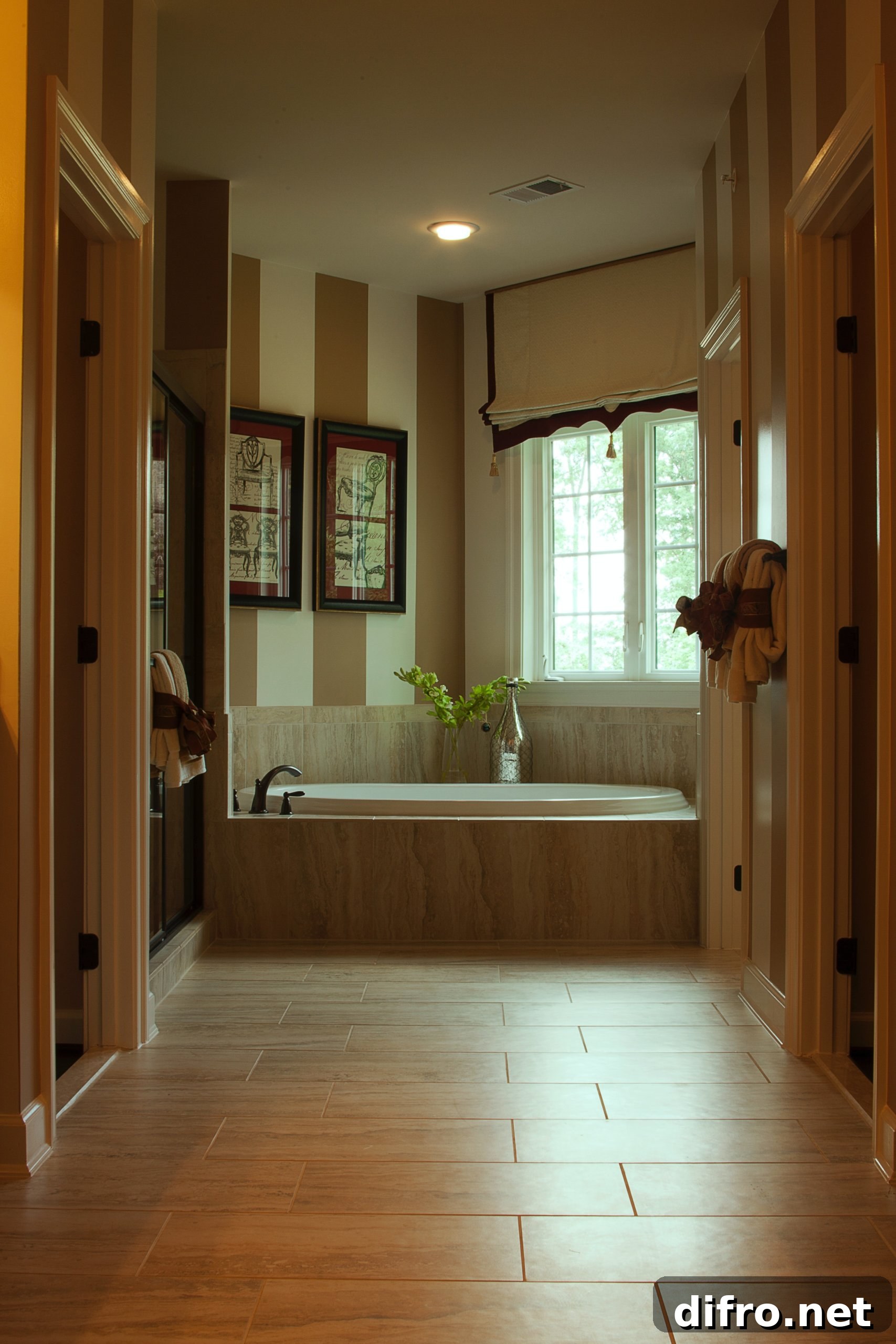 Neutral colored bathroom with frames and striped wall