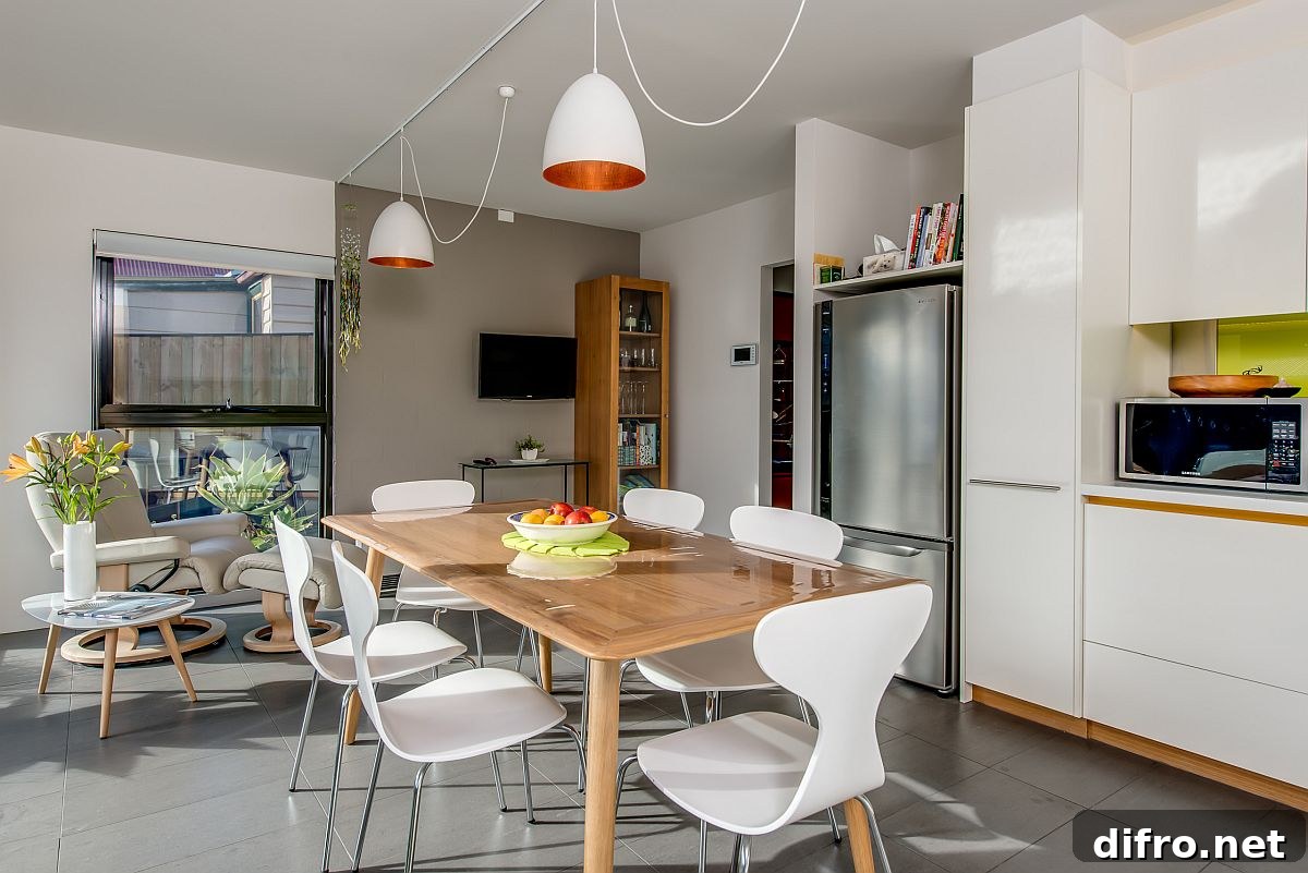 Kitchen and dining share wood and white color scheme
