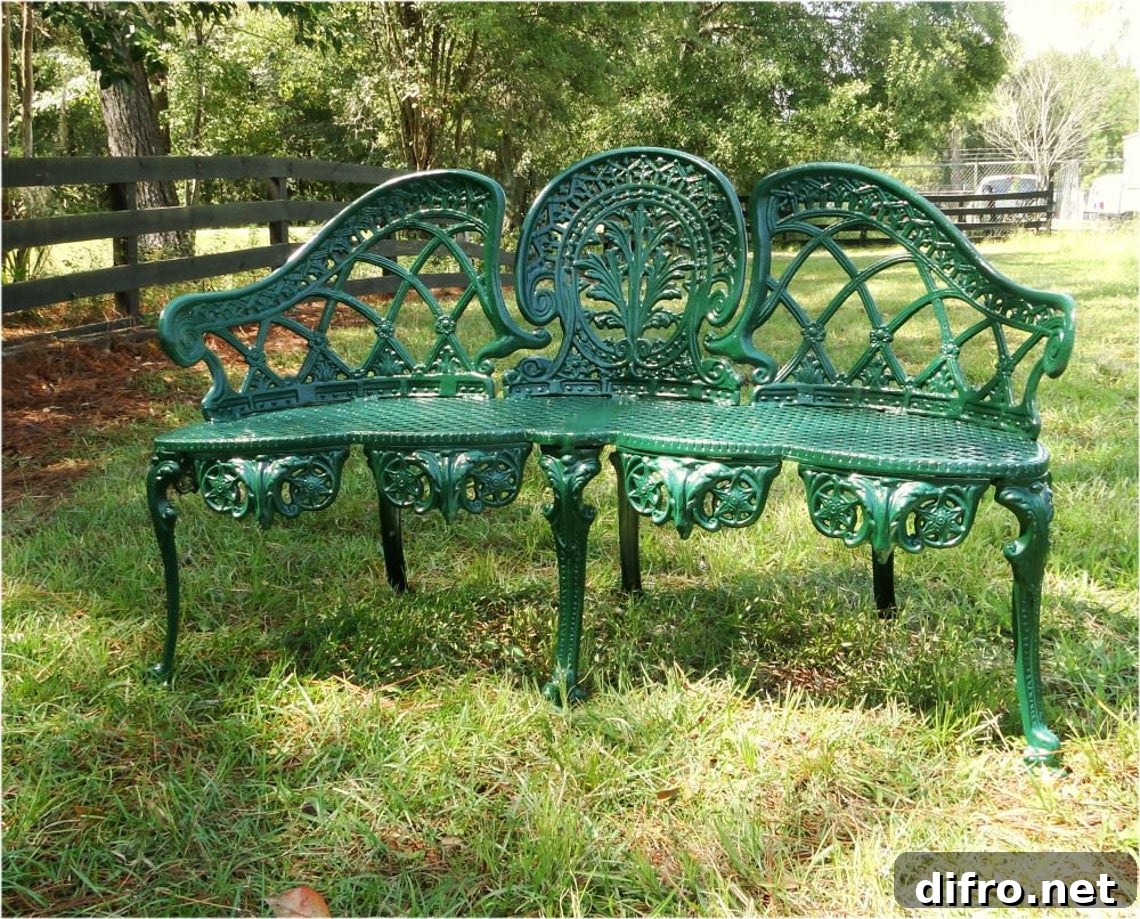 Green metal bench on grass
