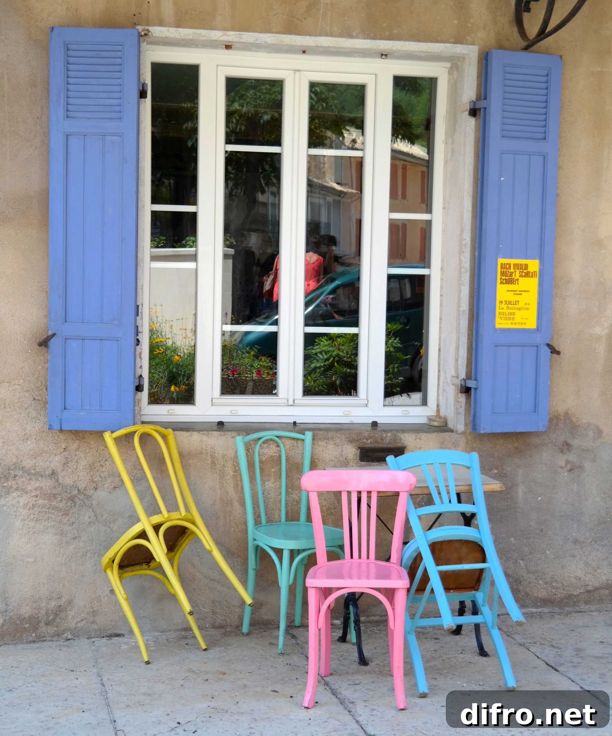 Blue and white window with four chairs