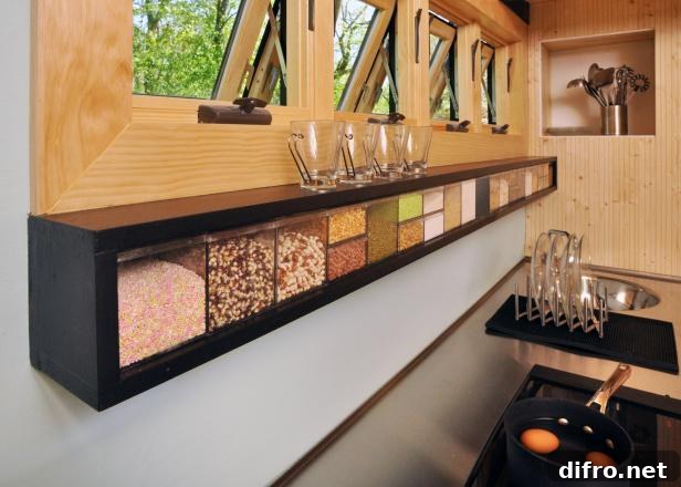 black skinny counter hanging spice storage with wood windows above