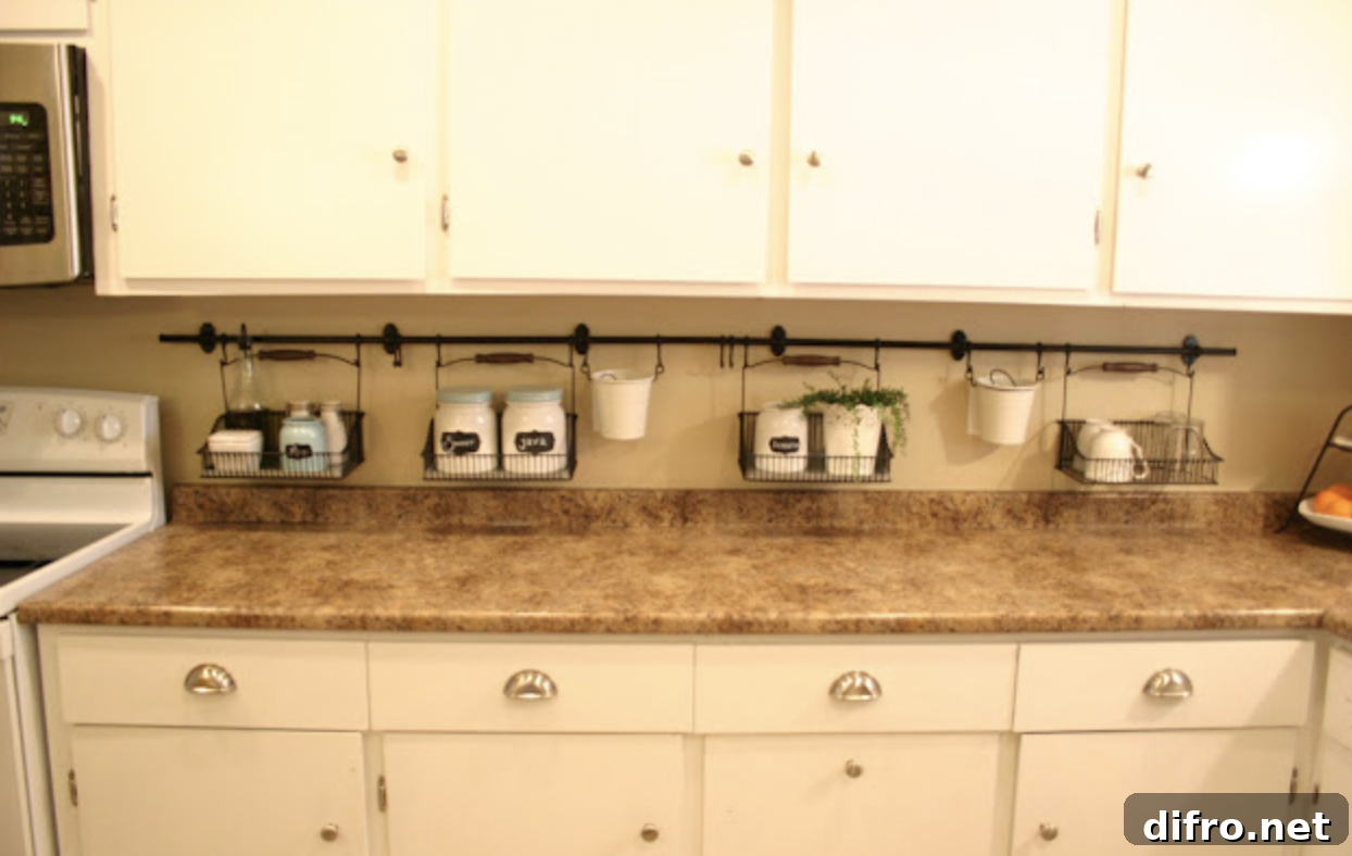 white kitchen cupboards with laminate countertops hanging black rod under cupboards with wire baskets