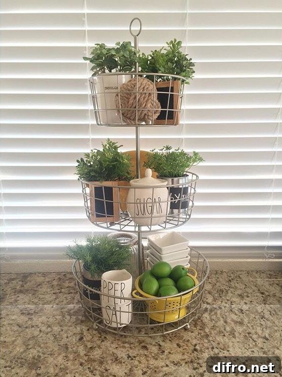 three tiered wire baskets on kitchen counter with greenery