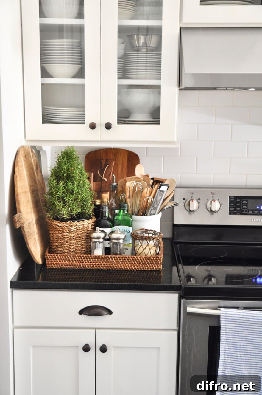 woven flat storage box on black kitchen counter next to stove with utensils and kitchen items