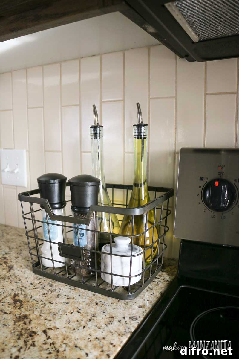 wire basket next to stove with oil bottles and salt and pepper