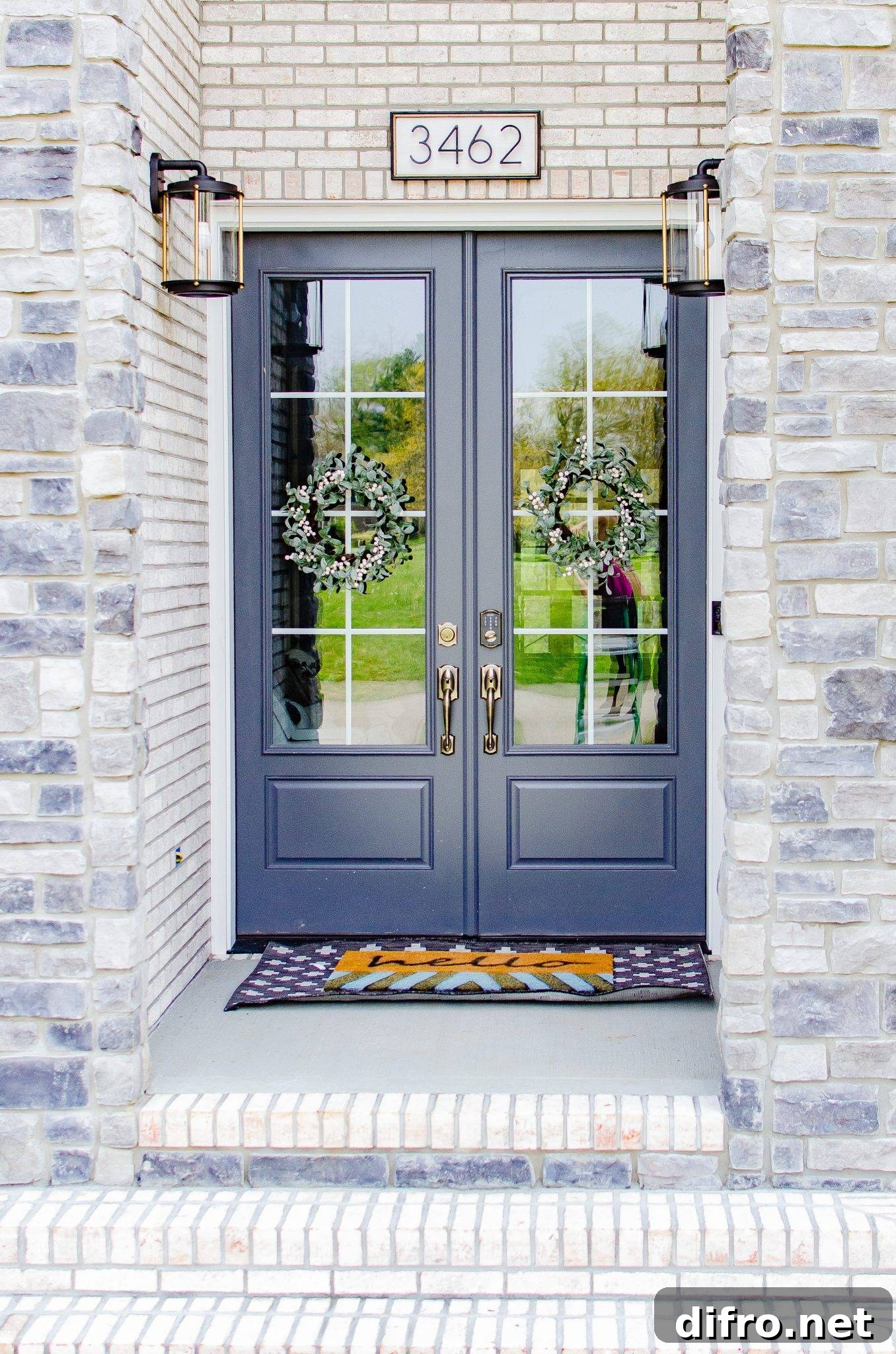 modern front porch with blue oreleans doors wreaths and modern diy house number sign