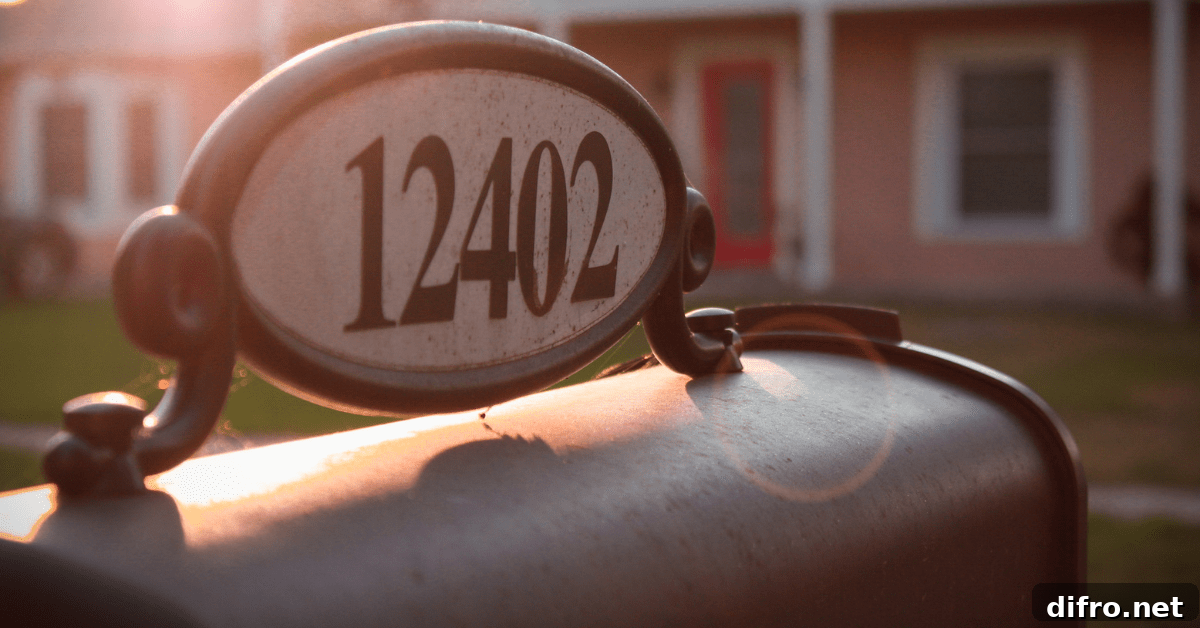 A house number attached to the top of a mailbox post.