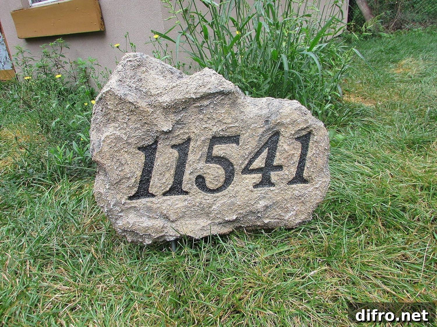 House number on a large stone.
