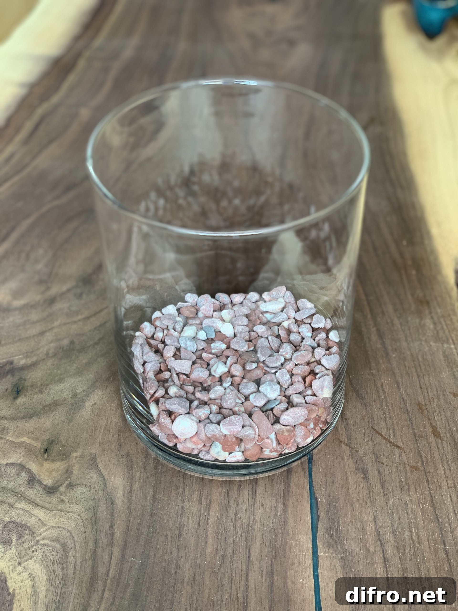 Decorative red and pink stones in glass terrarium