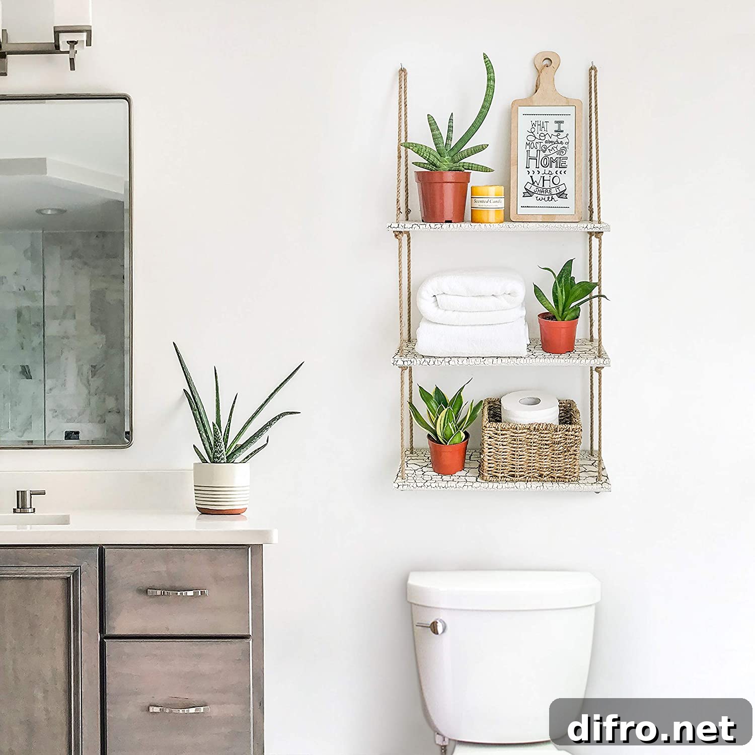 Hanging shelf with plants and towels above the toilet
