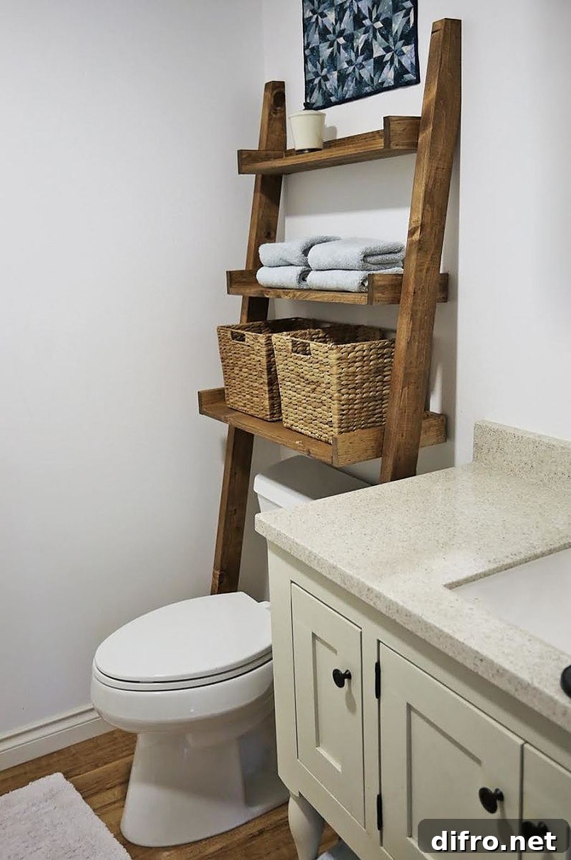 Ladder storage shelf leaning on the wall with wicker baskets and towels