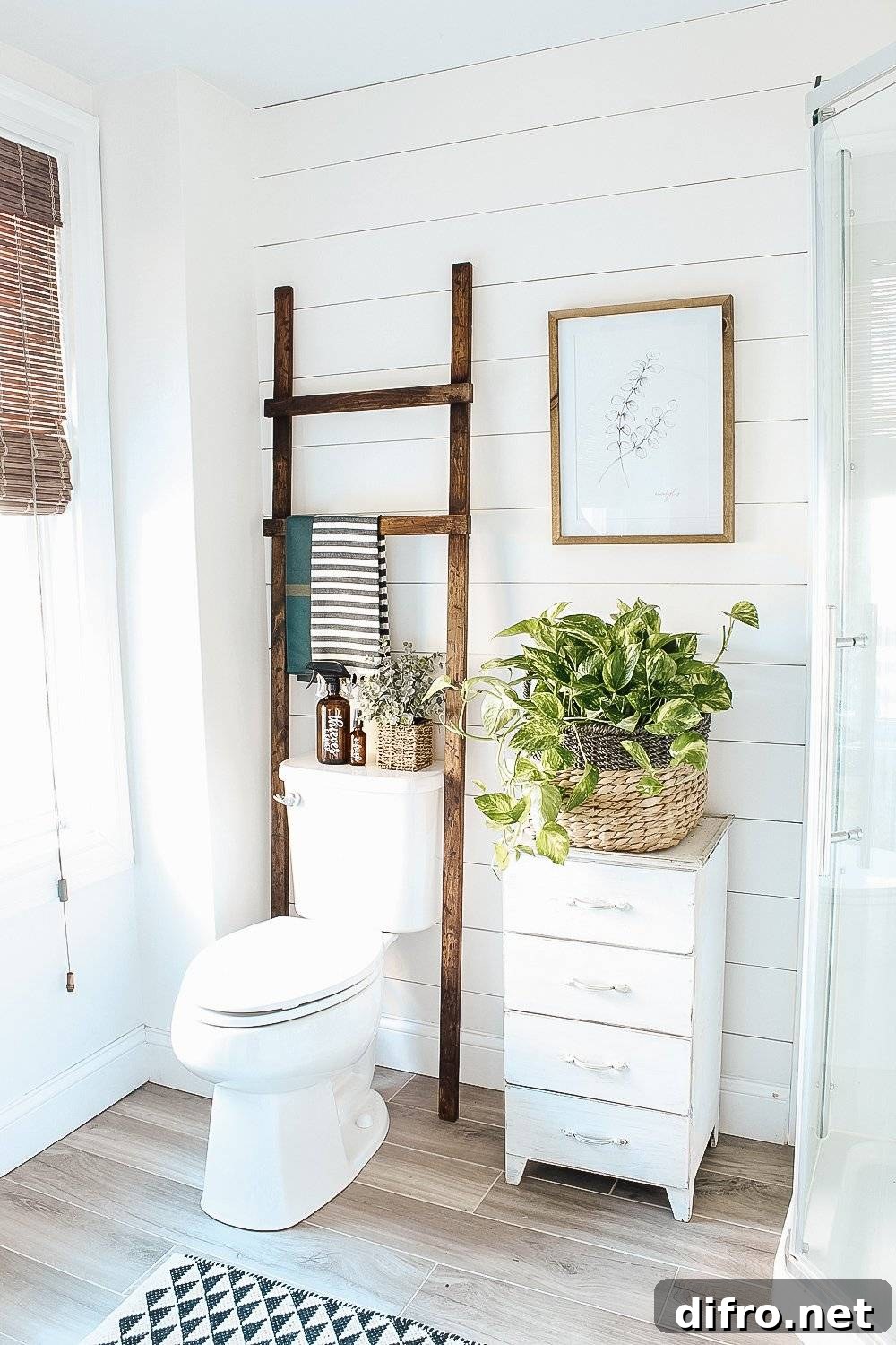 white shiplap wall bathroom ladder over toilet white four drawer shelf with potted plant