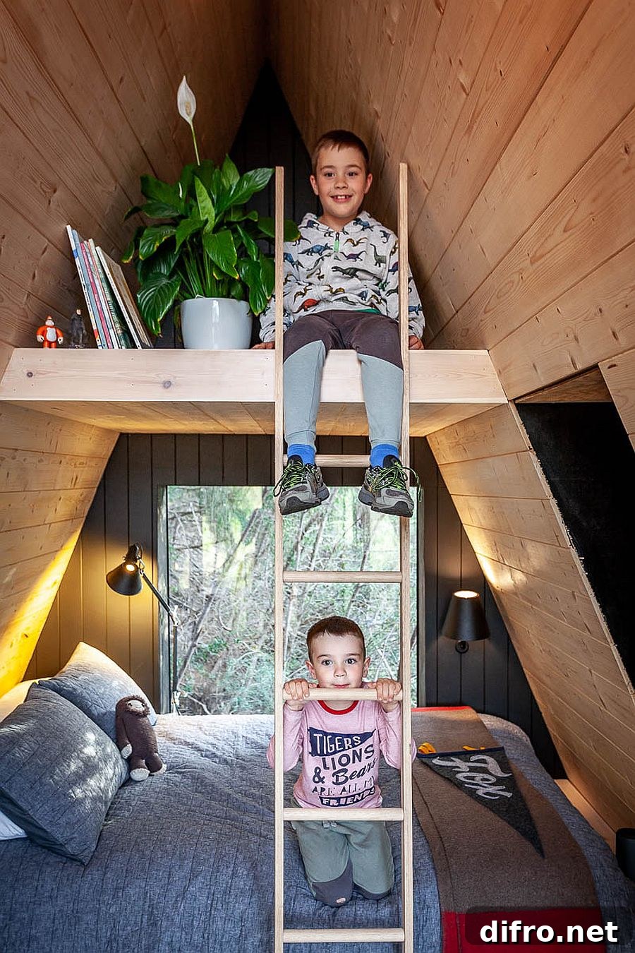 Children on the wooden ladder inside of the A-frame house.
