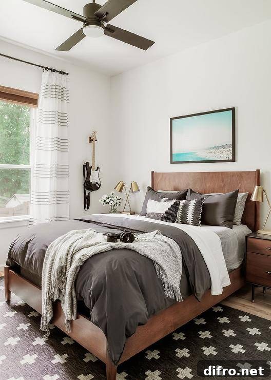 Dark gray bedding on a wood bed, beach art above