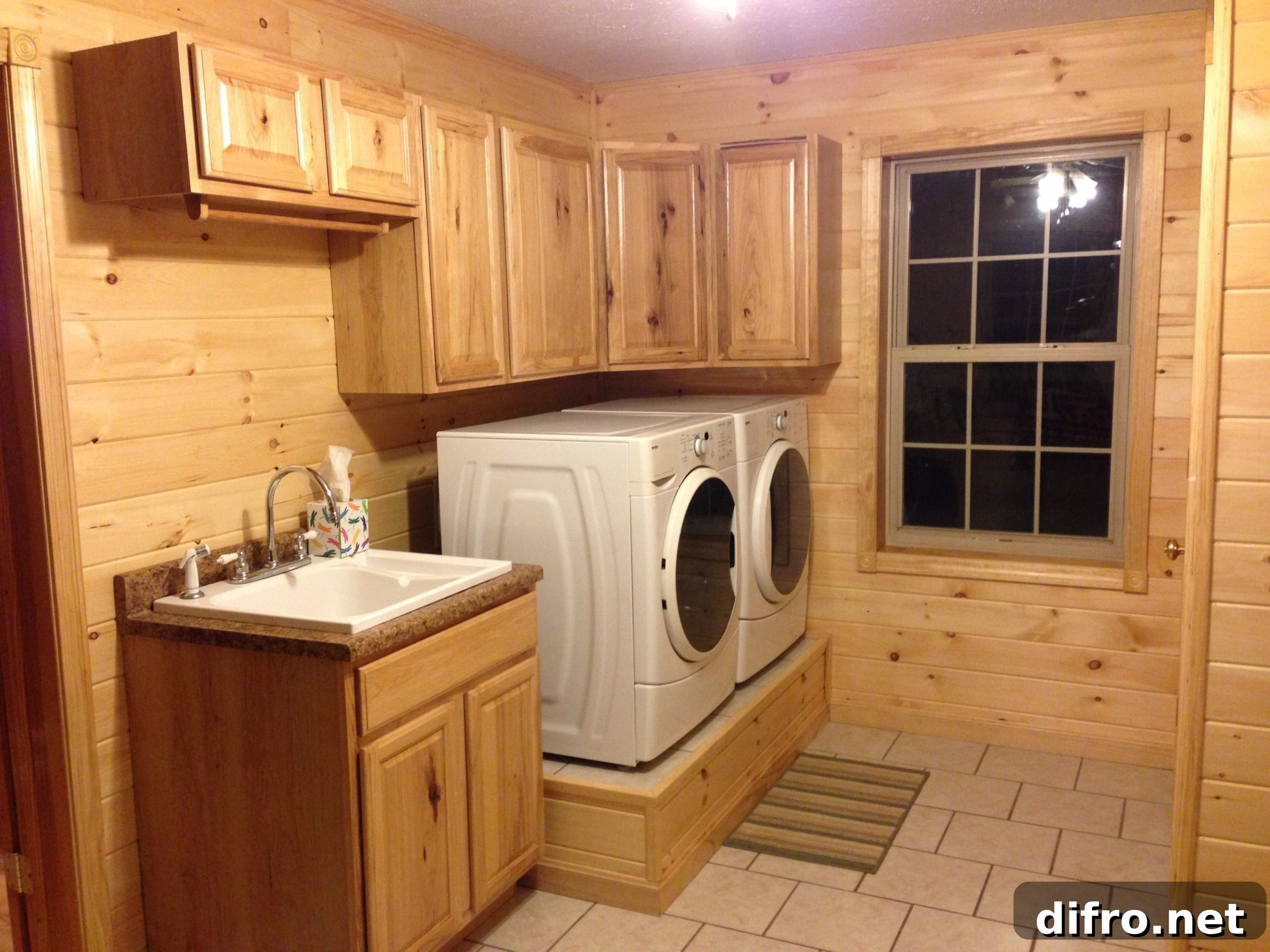 Washer and dryer on a platform beside sink