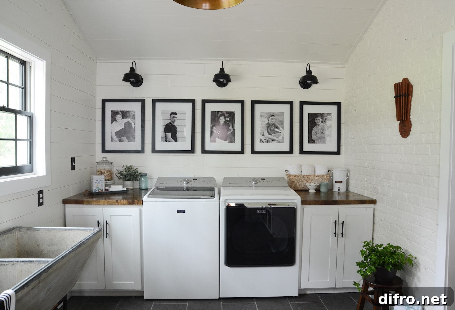 Black and white photos hanging on the wall in the laundry room
