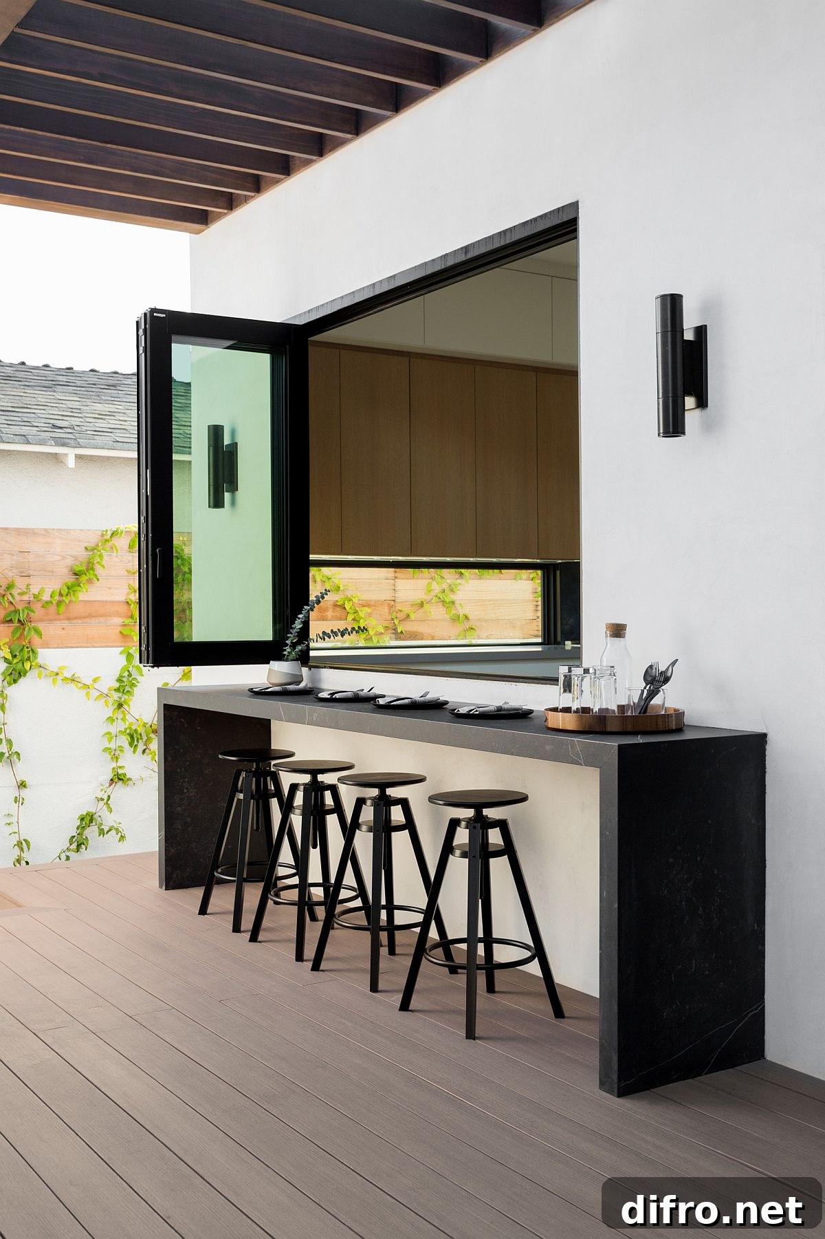 Window connecting indoor kitchen to outdoor kitchen