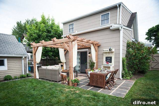 Light wood pergola with seating area and curtains
