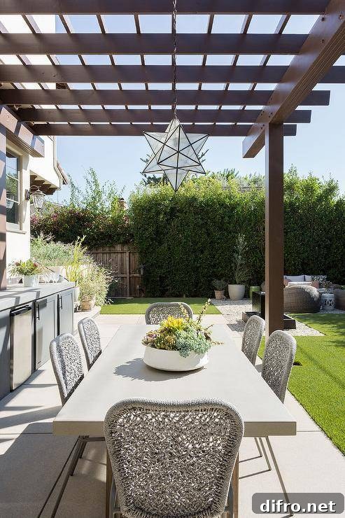 Moravian star pendant light hanging over an outdoor dining table under a pergola