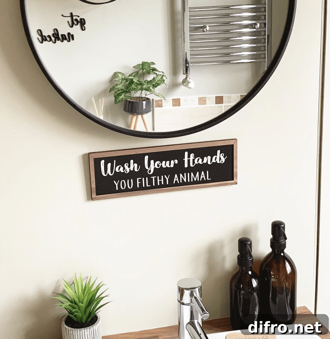 round black mirror bathroom sign amber bottle soap dispensers greenery