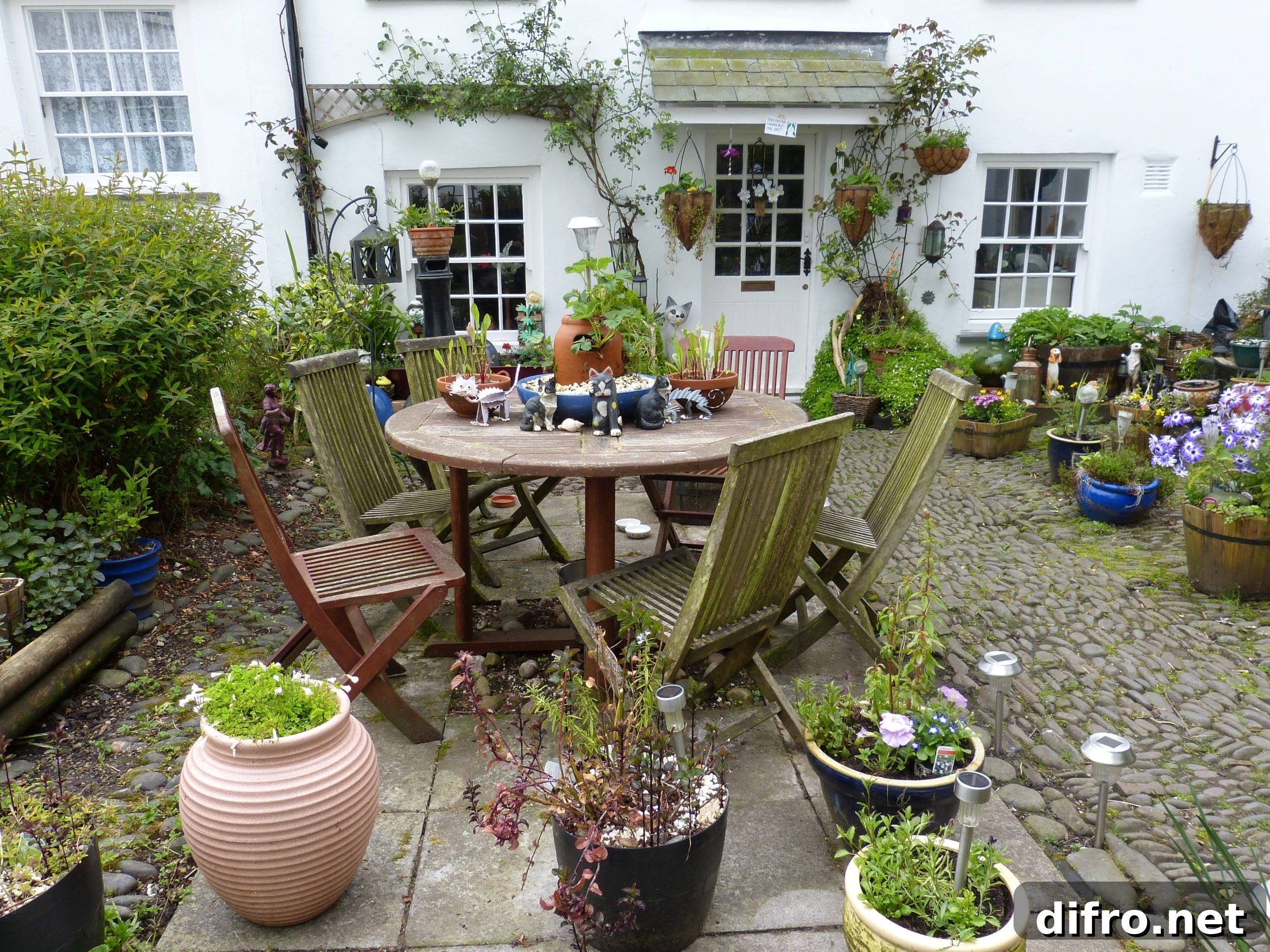 Cottage courtyard with potted plants and seating