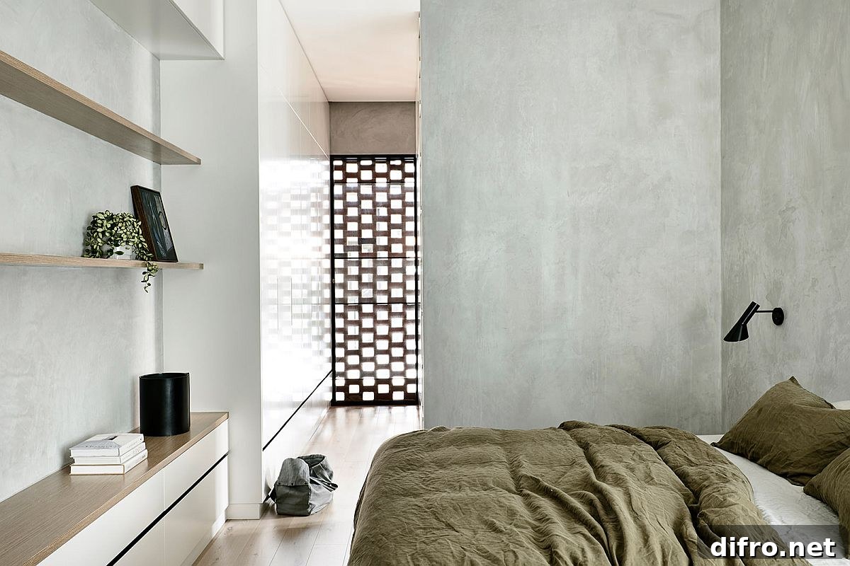 Modern minimal bedroom with gray walls and ample natural light on the upper level