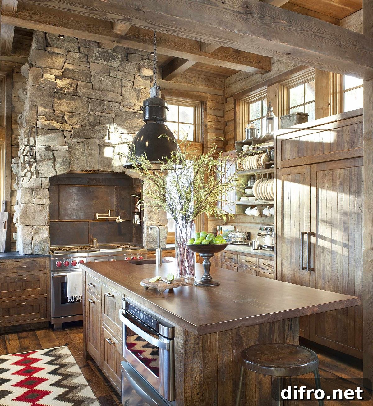 Spacious rustic kitchen with wooden countertops, cabinets and custom metal range