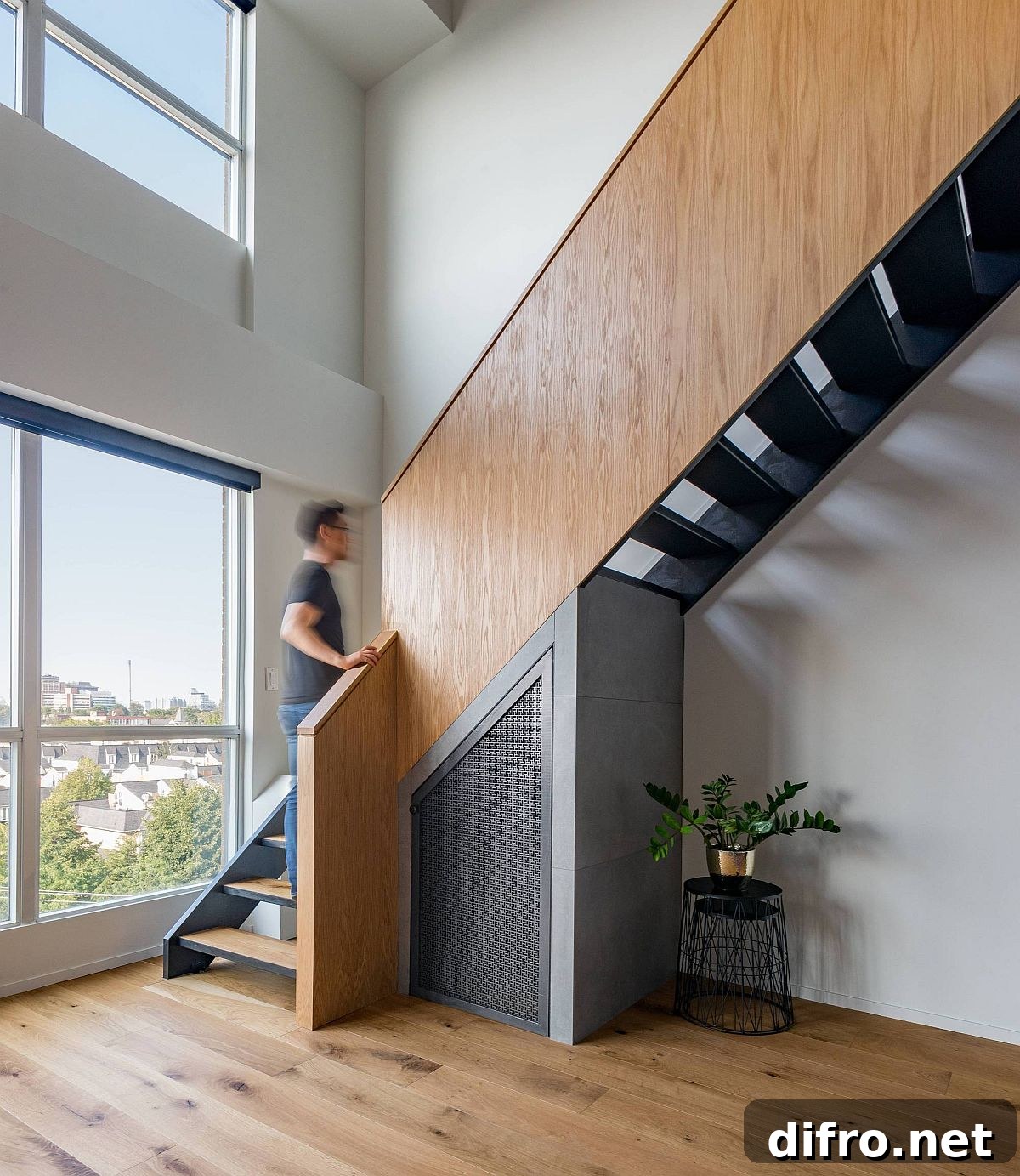 Revamped staircase in wood and metal connects the two levels of the loft home
