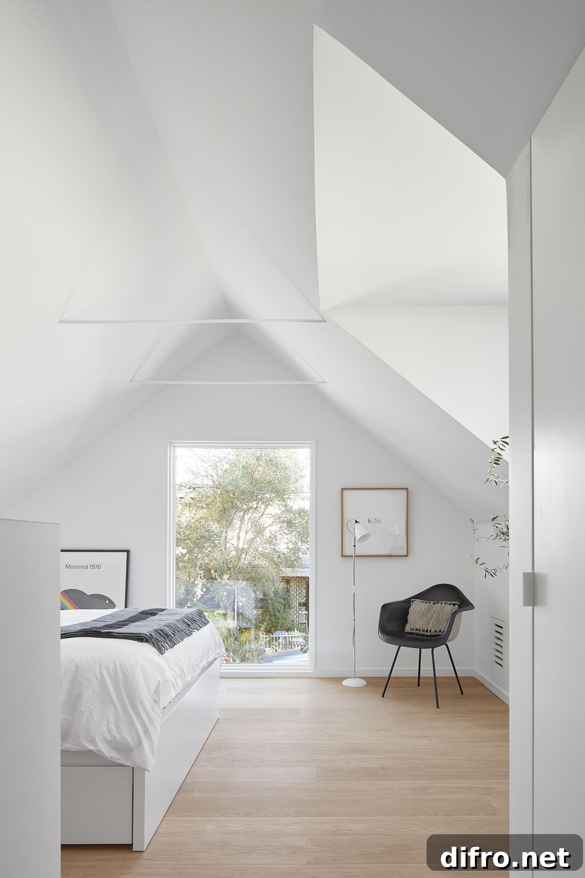 Glass window and skylight bring ample natural light into the bedroom on the upper level