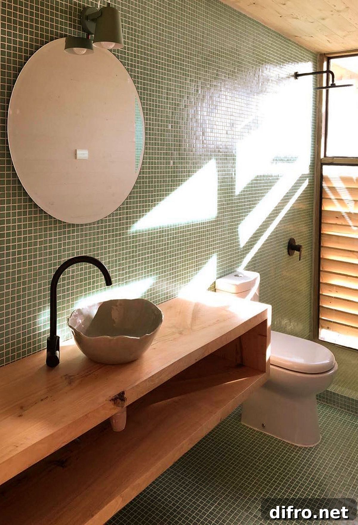 Green bathroom tiles adding color to the modern space