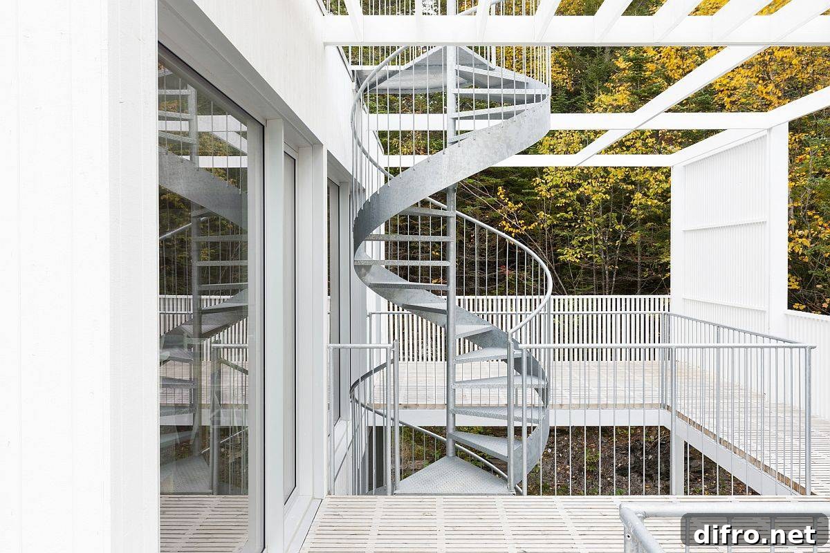 Fabulous metallic spiral staircase connects the three different levels of the house