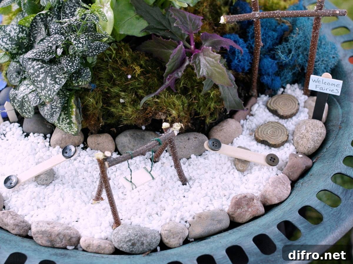 Miniature swing and slides on top of white pebbles surrounded by plants