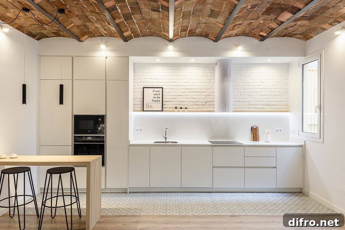 White and wood kitchen with ceiling tiles and exposed brick