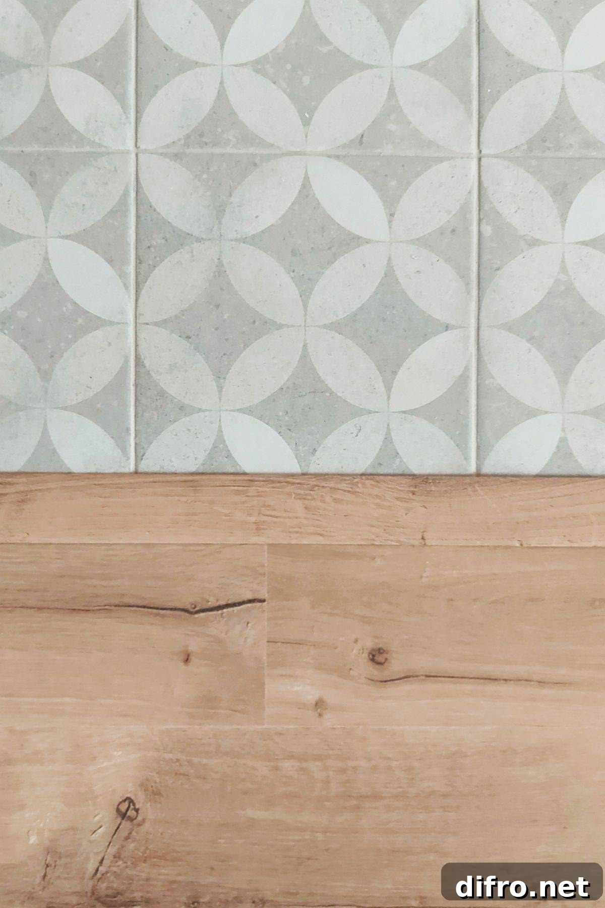 Patterned tile floor next to wooden living room floor