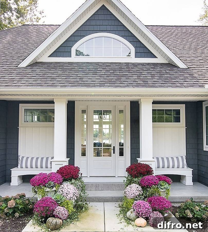 Different shade of purple flowers in front of a house