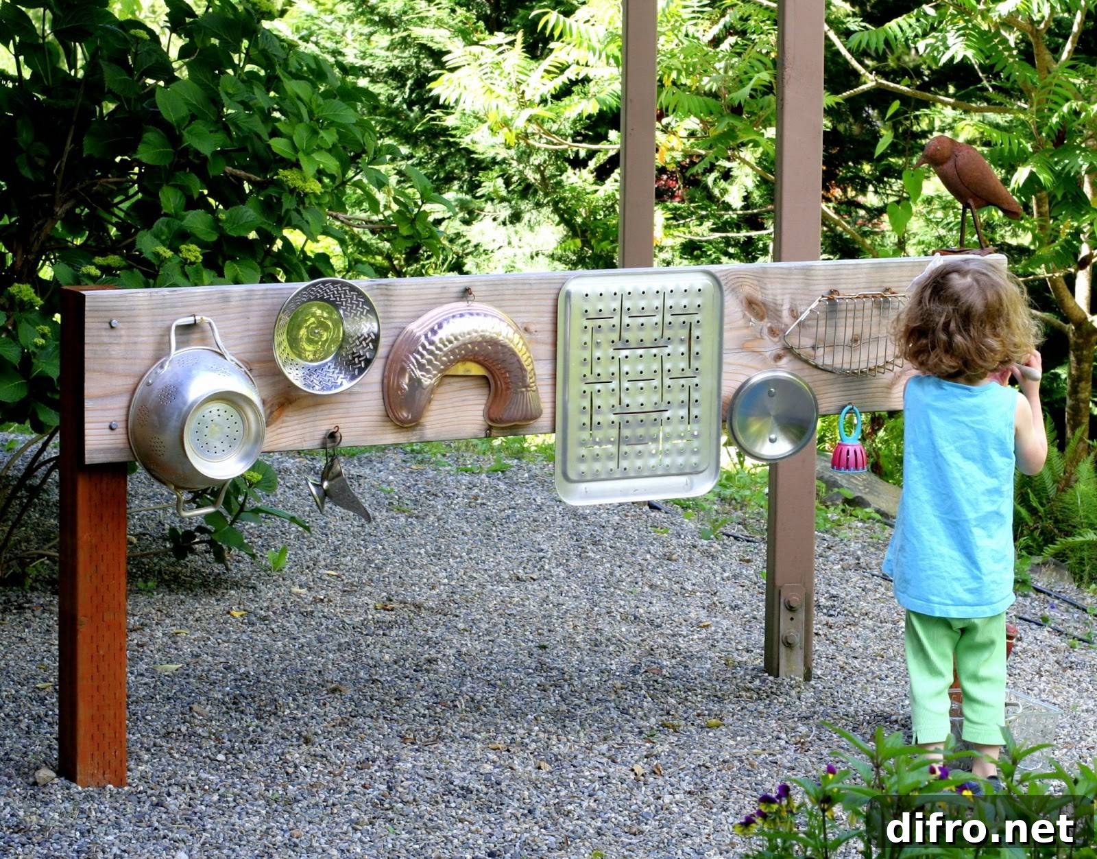 Little girl in blue facing different metal wares hanging on a wood