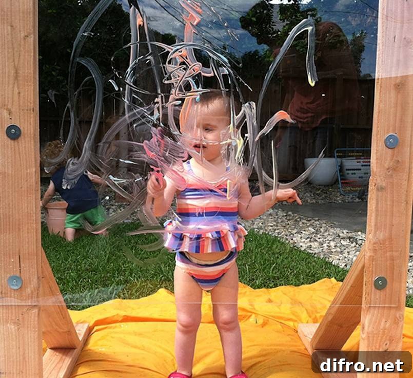 Toddler painting on a clear board