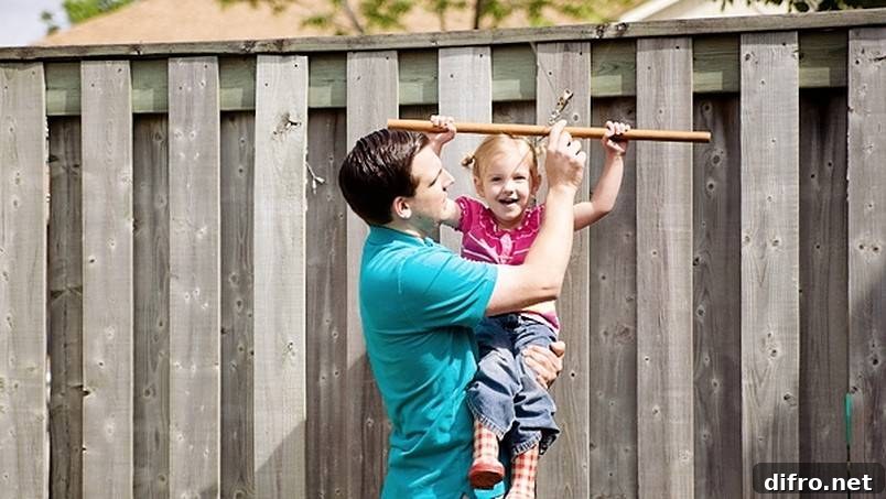 Father holding daughter while on a zip line