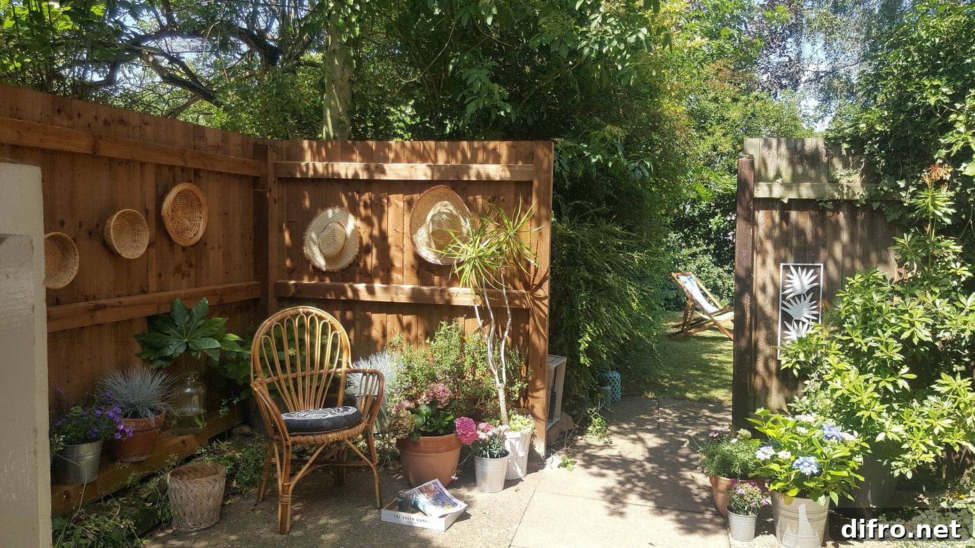 Walled garden with rattan baskets, hats and wicker chair