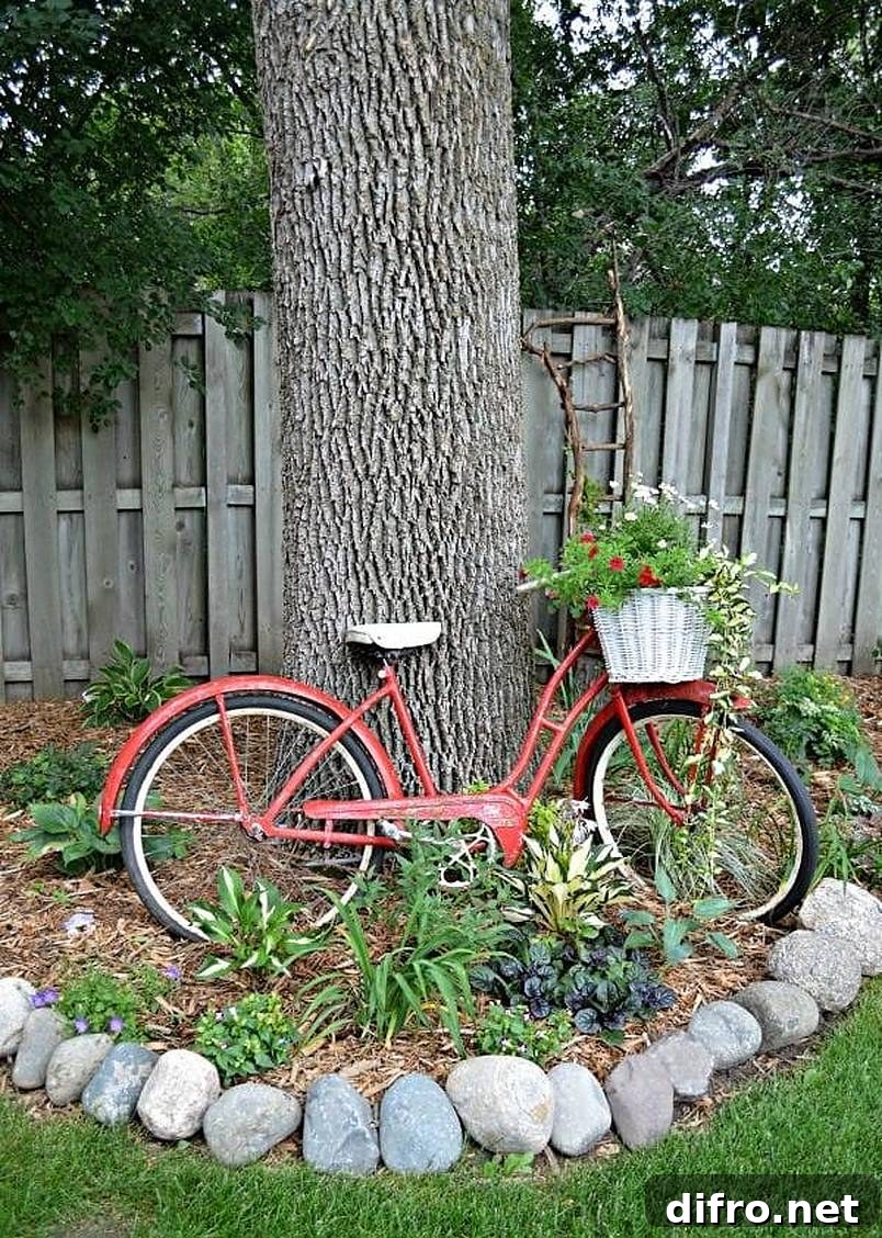 Old red bike leaning against a tree