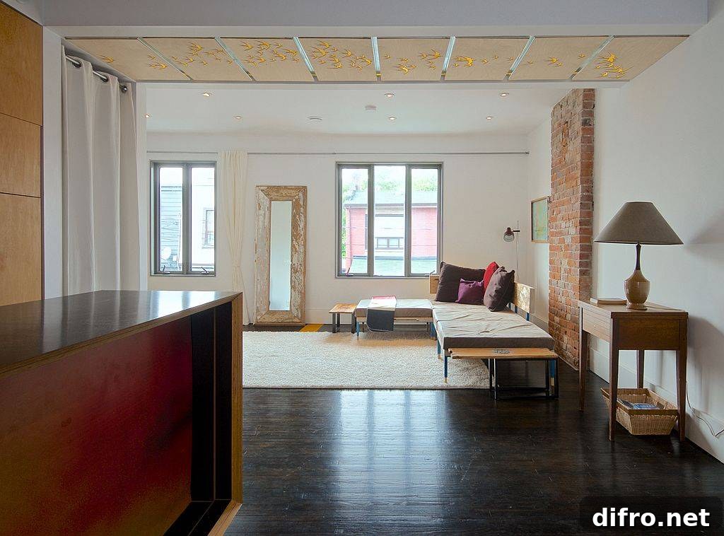Brick wall section coupled with custom ceiling and a white backdrop inside the living room