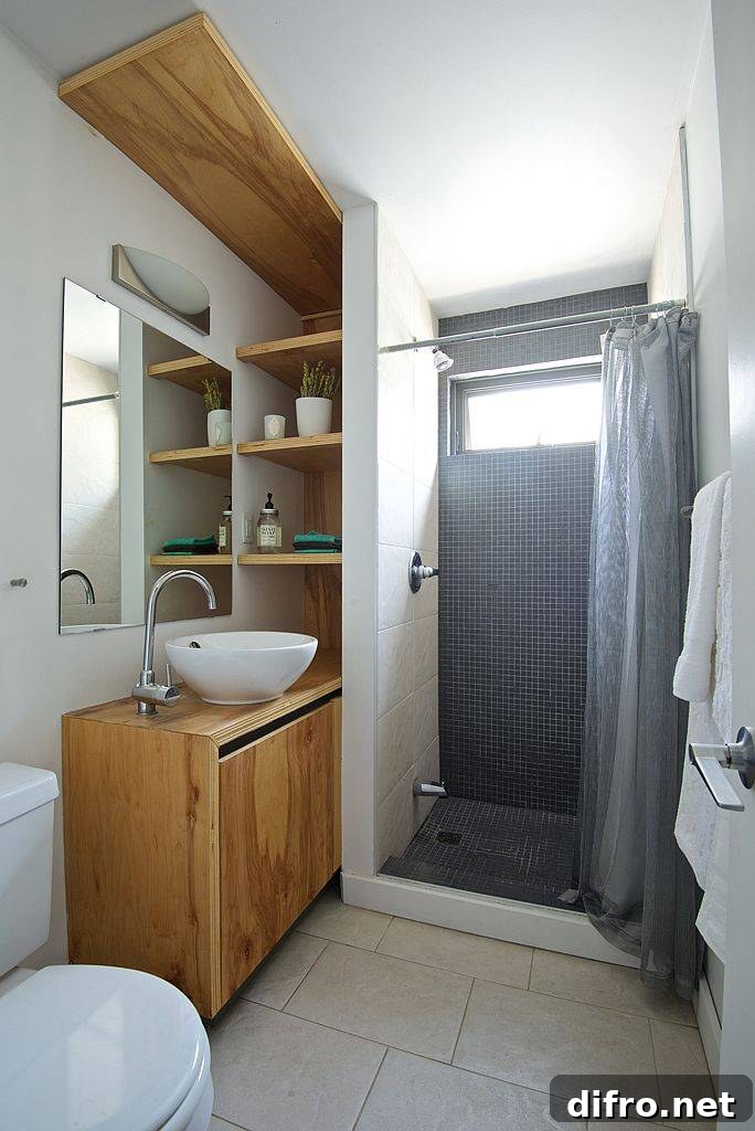 Tiny bathroom with space-savvy design and a wooden vanity