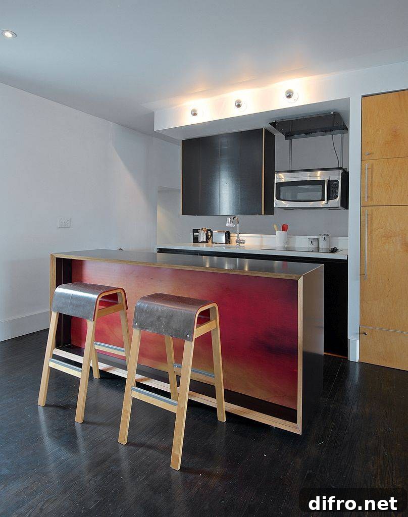Bespoke kitchen island in wood and metal with bar stools that have a matching finish