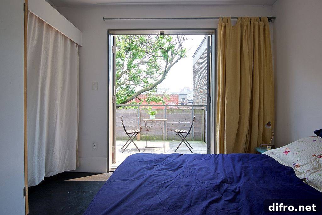 Bedroom doors slide open to connect it with the small balcony outside