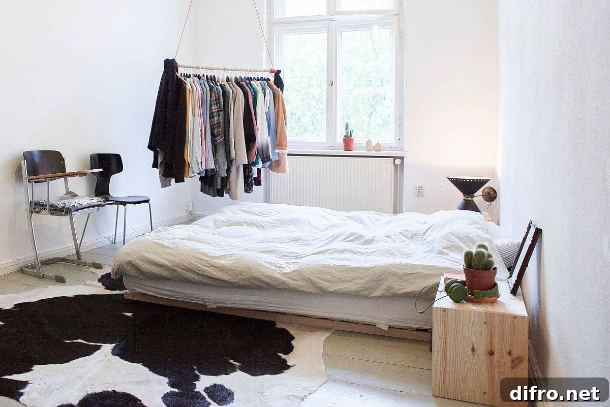 Minimal closet with metallic bar hanging from the ceiling