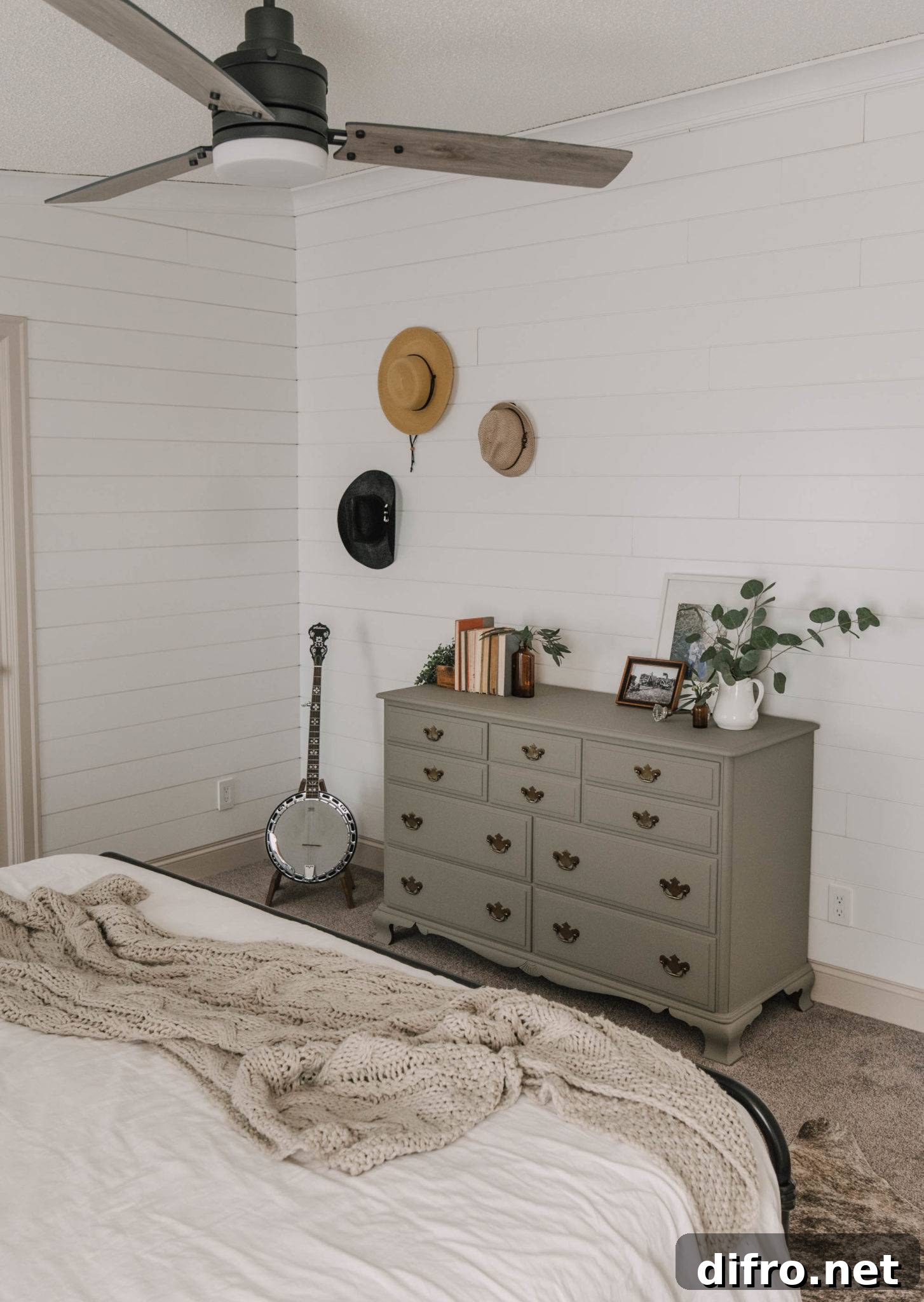Decorative cabinet and hats on white wall
