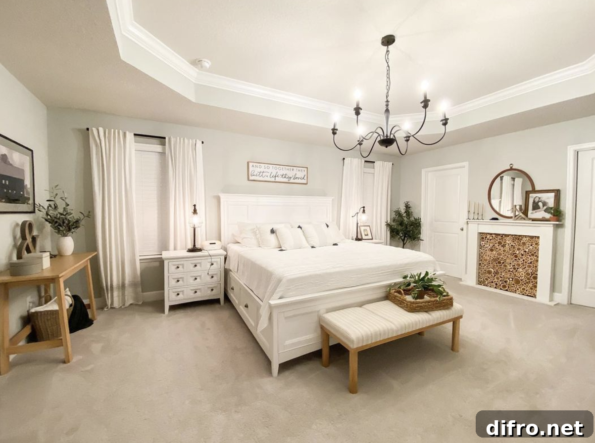 Large white farmhouse bedroom with chandelier