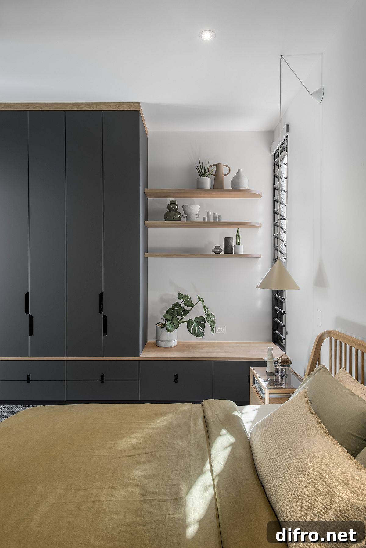 Compact bedroom in white with dark gray cabinets